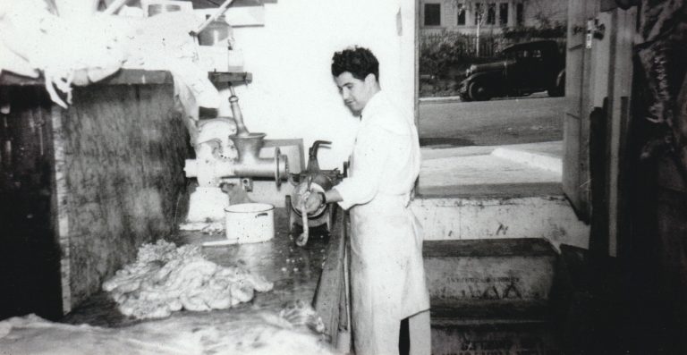 1940's Maestro Sausage born at Eastside Italian Deli. Gaetano (George) Laricchia making sausage near the back door at Eastside which is now closed off and is now the dining area of Eastside Deli.